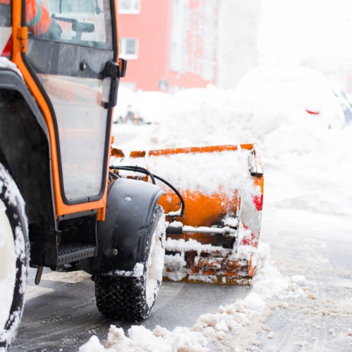 Schneepflug räumt die Straßen in der Stadt, Winterdienst